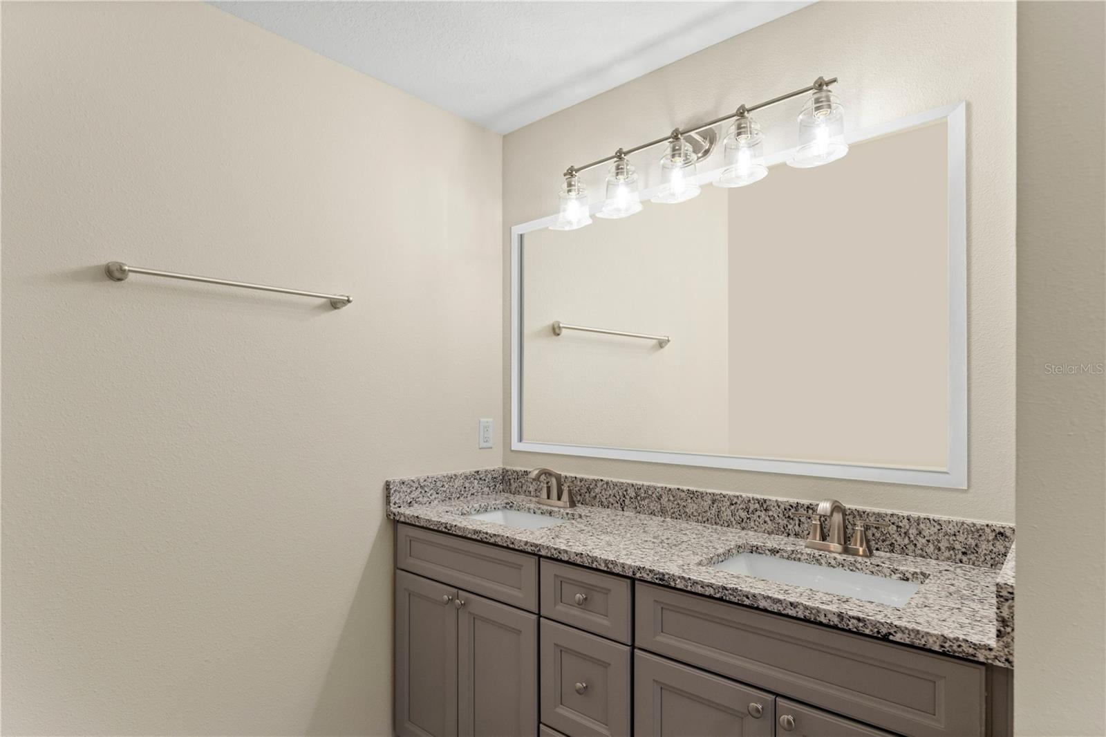 Dual granite countertop owners suite bathroom with separate water closet