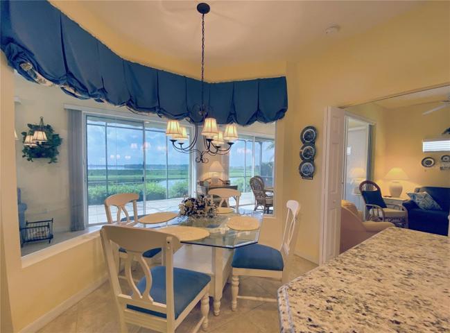 Dinette Area with Glass Window Allows Natural Light and Water View