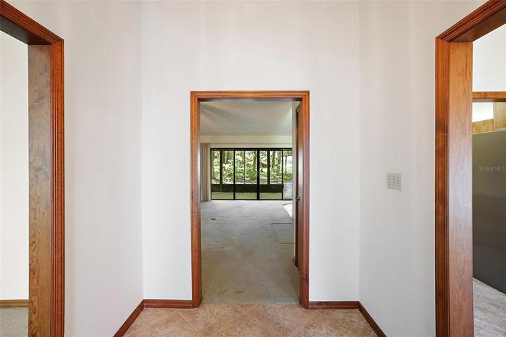 Foyer entrance flanked by living, dining and family rooms