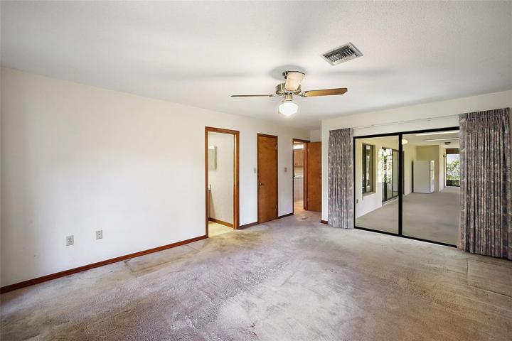 Master Bedroom with walk-in closet, en-suite bath and sliders that lead to the spacious lanai