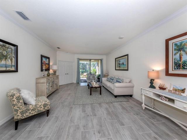 Living area open to lanai with French Doors leading to Primary Bedroom