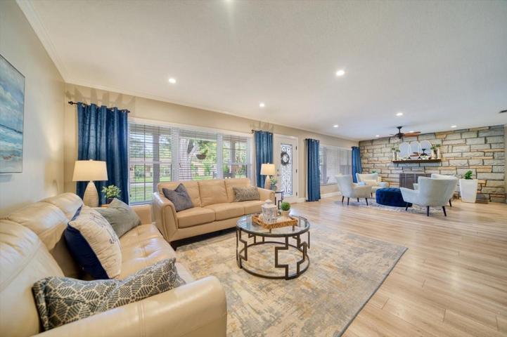 Another view of the entrance into this home and the spacious living room with room for two sitting areas.