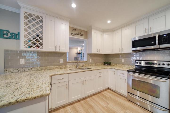 Updated kitchen with plenty of counter space, a wine rack, and stainless steel appliances.
