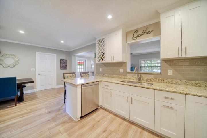 Updated kitchen with bar stool seating, right off of the dining space