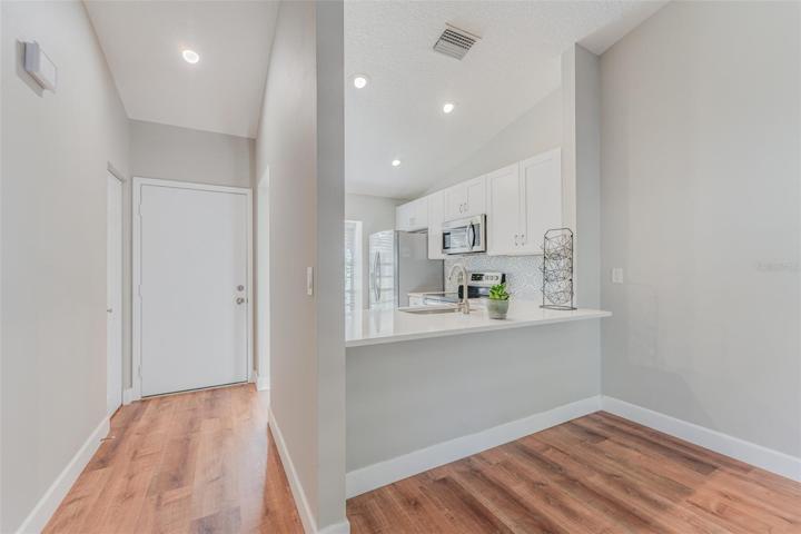 Living room towards kitchen & main entrance