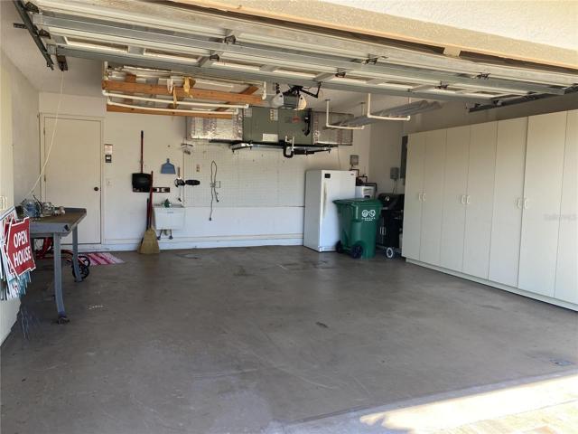 Inside of 2 Car Garage with cupboards, sink, workbench & refrigerator
