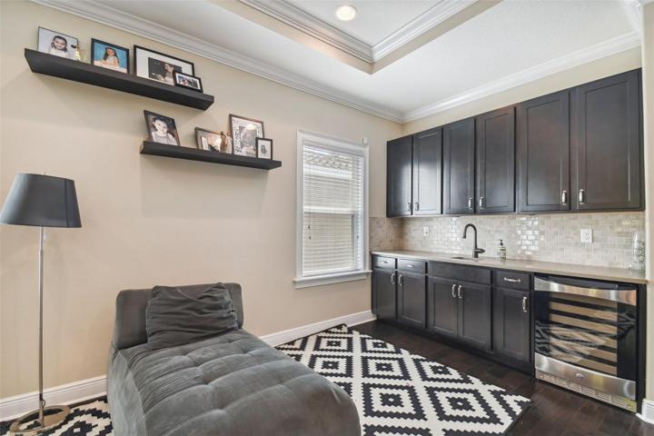 2nd floor loft with wet bar, cabinets, and wine refrigerator