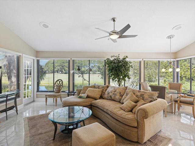 Living Room off the kitchen with added dining table to watch the wildlife/Door leading to patio