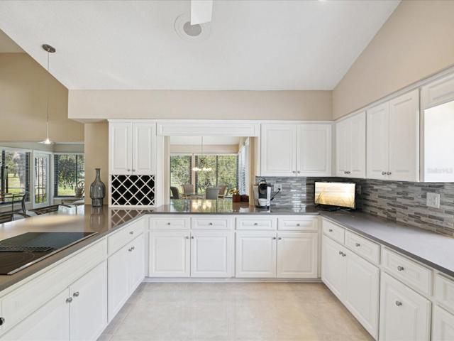 Kitchen pass through to family/living room overlooking pond and golf course