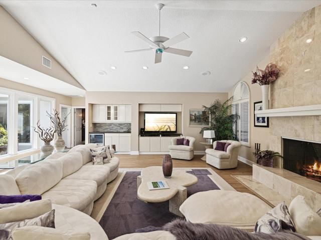 Great Room with wood burning fire place w/ marble surround, wet bar