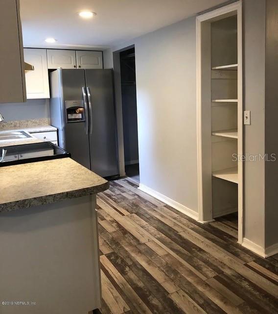 Wall by fridge has been updated to open shelving.