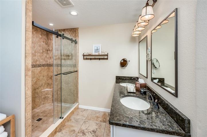 Remodeled primary bathroom with dual sinks and new vanity