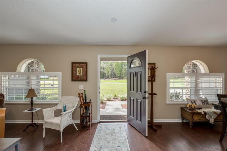 Front entry into living / dining combo room with new plantation shutters