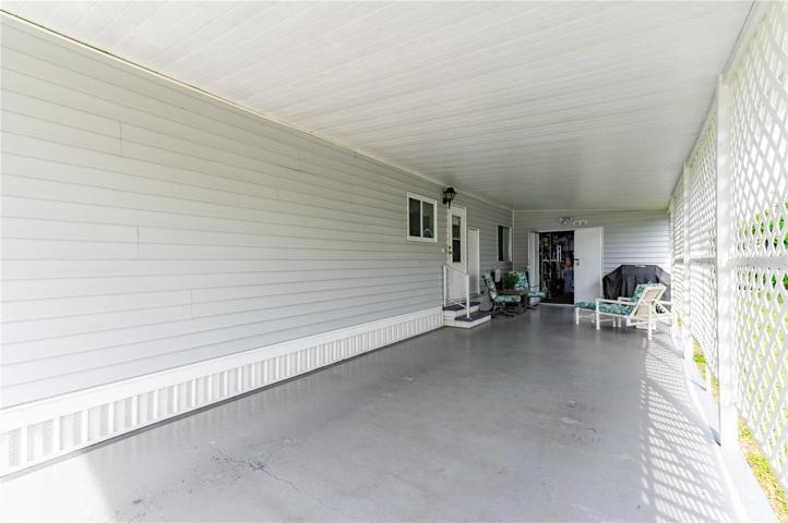 Double carport has a painted driveway.