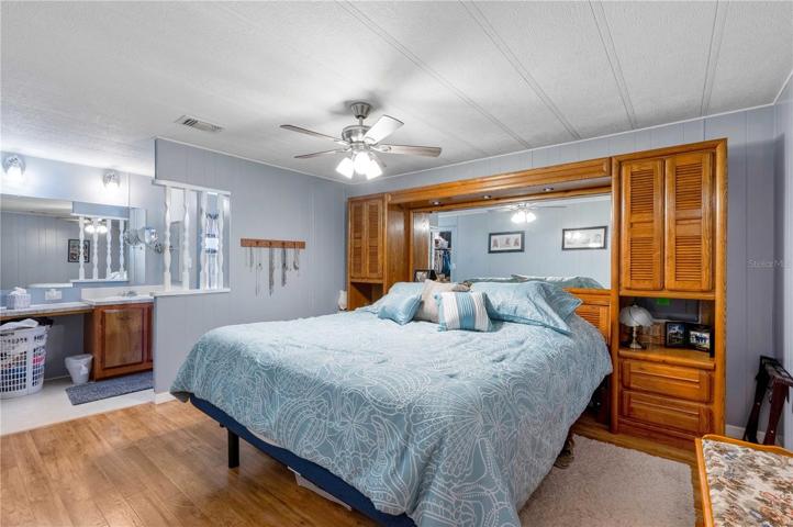 Master bedroom can support a king size bed, updated ceiling fan, laminate flooring, and walk-in closet.