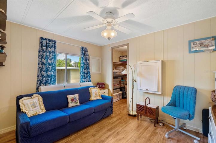 Bedroom two has laminate flooring, ceiling fan, and walk-in closet.