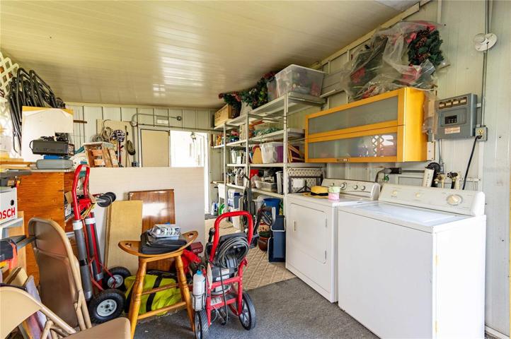 Laundry area is located off carport in golf cart garage.