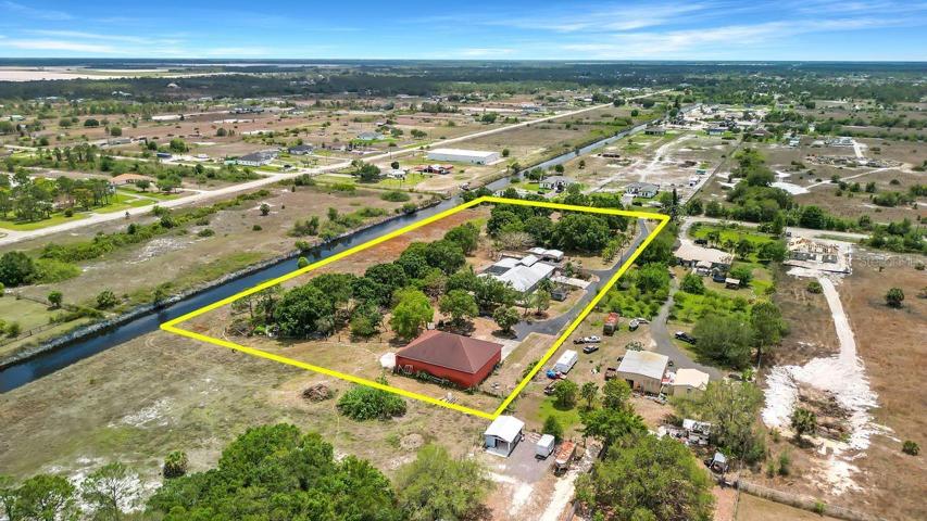 ariel view over NW corner property line extends halfway across canal showing part of sold acreage purchasable