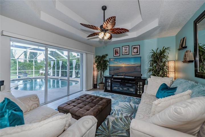 family room has double coffered ceilings plus pool access