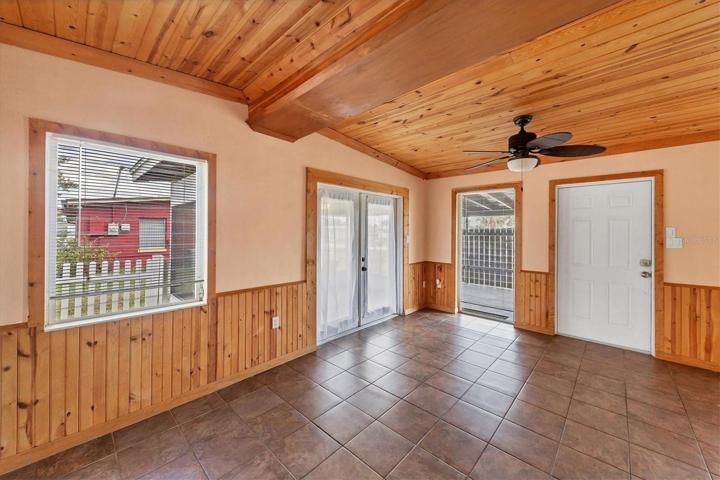 VIEW FROM LIVING ROOM , FRENCH DOORS ON LEFT TO LANAI AND FRONT ENTRY DOOR MIDDLE