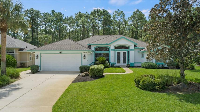 Beautifully landscaped and backing up to wooded nature preserve