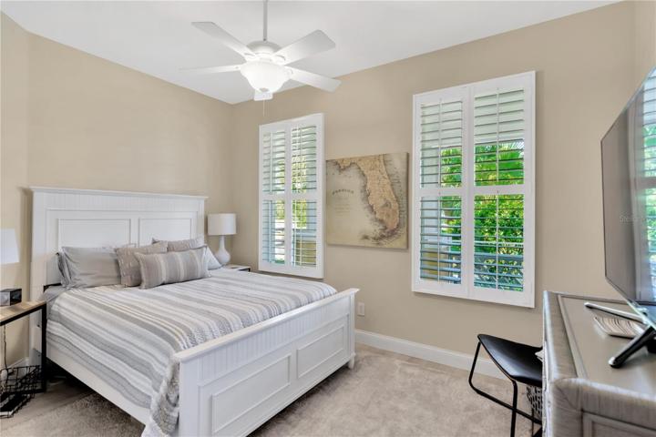 2nd Bedroom w/Large Area Rug and Plantation Shutters
