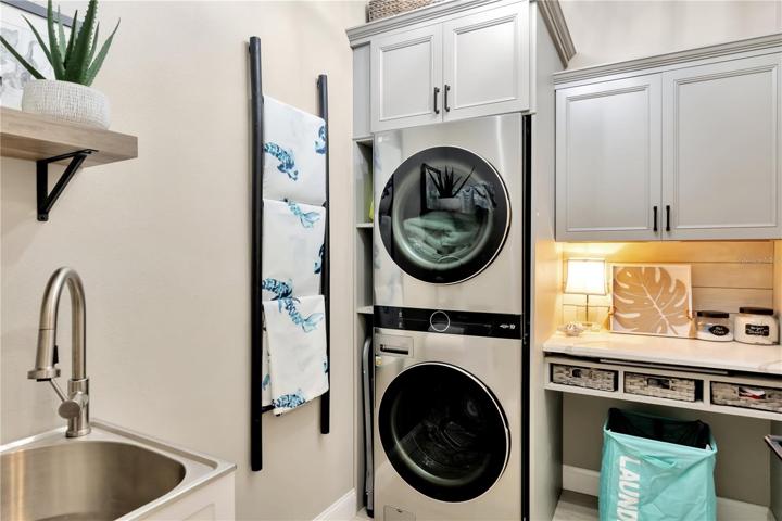 View of Completely Updated/Upgraded Laundry Room w/ Custom Cabinetry & Granite Top Folding Shelf!