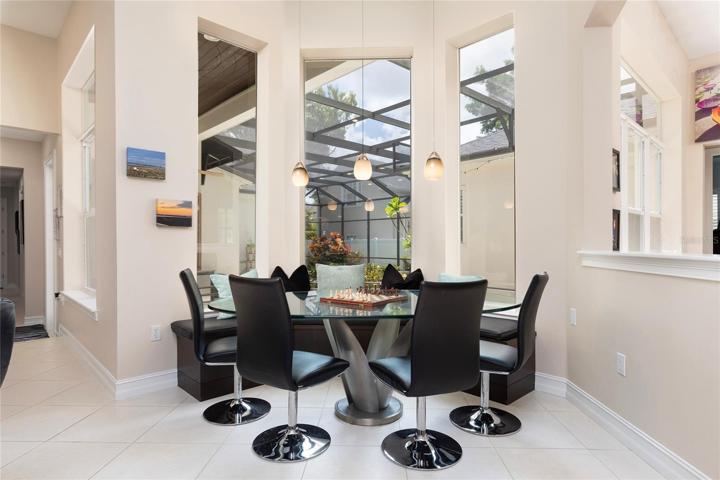 Breakfast Nook with built in bench seating overlooks pool and lanai.