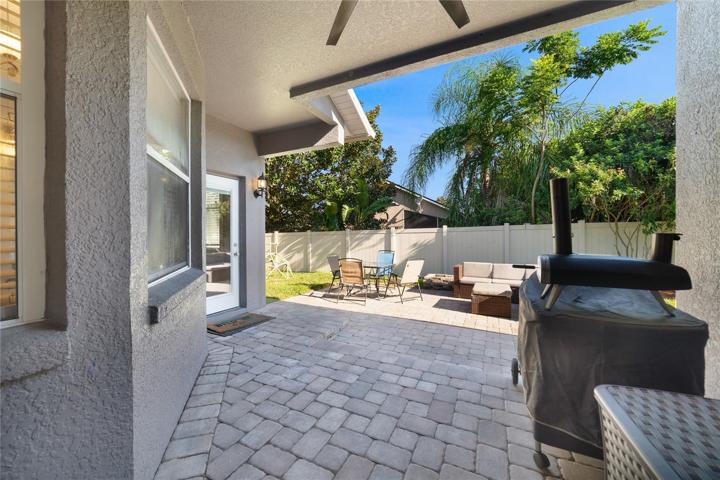 The covered paver lanai is the perfect place to spend a weekend and it extends out into the FULLY FENCED backyard!