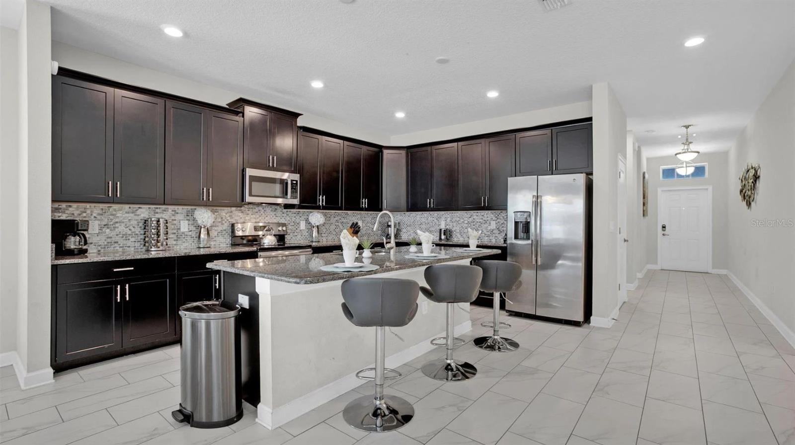 There are TILE FLOORS throughout the main living areas for easy maintenance and the bright OPEN CONCEPT is ideal!