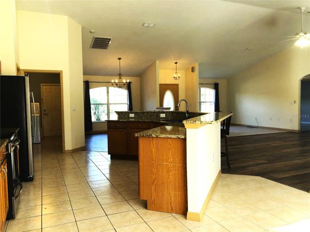 DINETTE THRU KITCHE TO FORMAL DINING AND OPEN FAMILY AREA