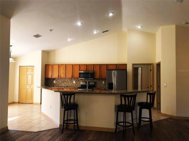 KITCHEN ISLAND & PANTRY CLOSET ON LEFT FROM LIVING ROOM