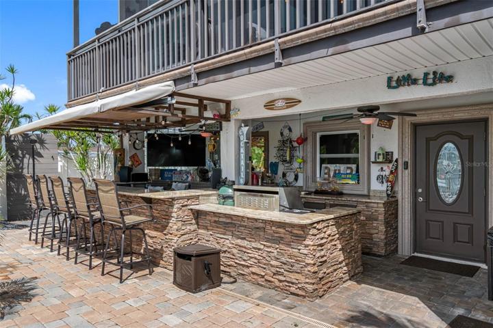 Outdoor kitchen with granite counters.