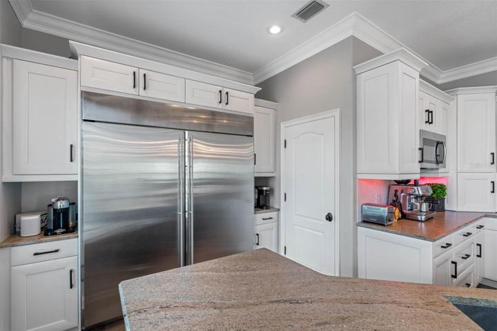 Double refrigerator and freezer.  Enormous walk-in pantry through doorway.