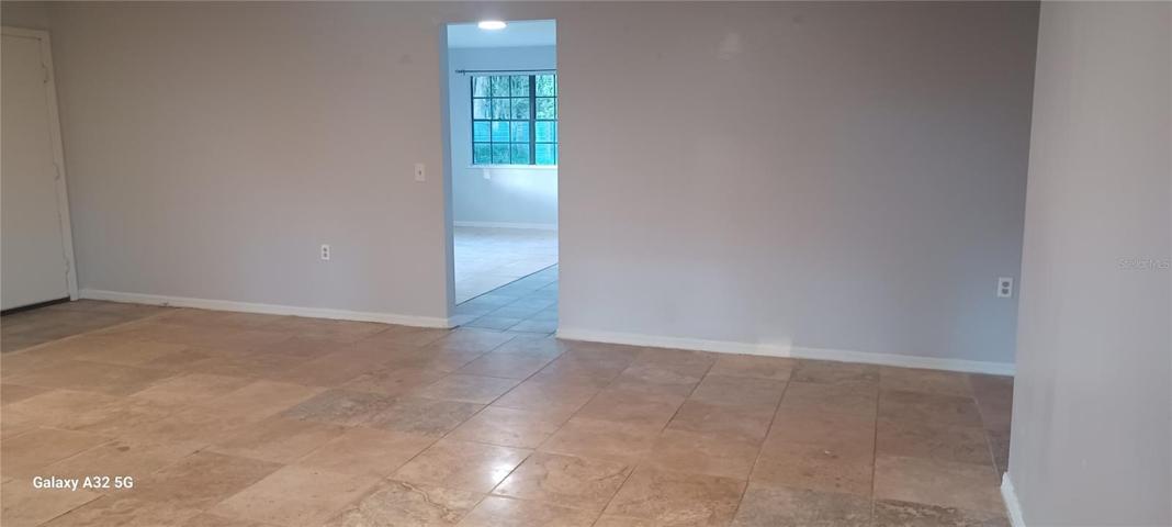 living dining room combo with travertine floor