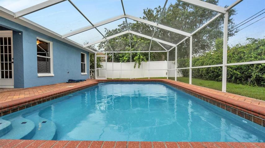 In-ground pool with pavers, screened in with plenty of privacy