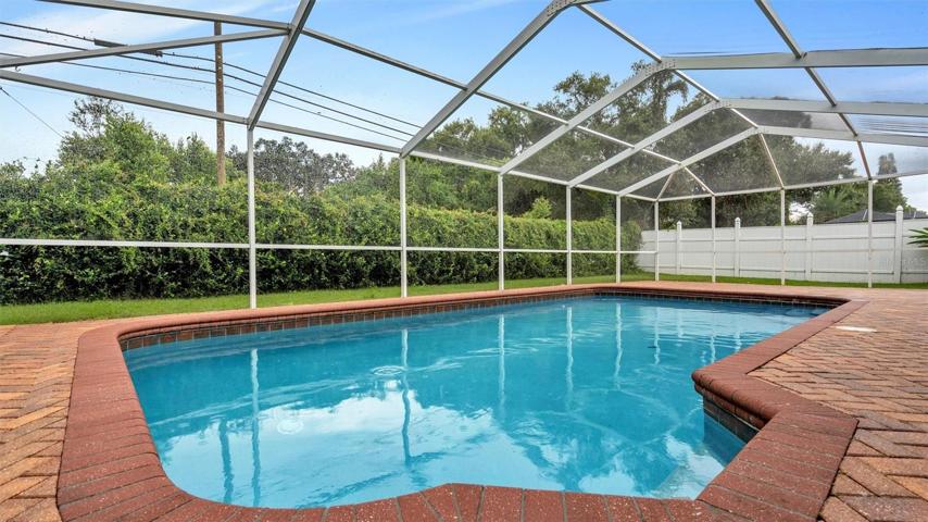 In-ground pool with pavers, screened in with plenty of privacy