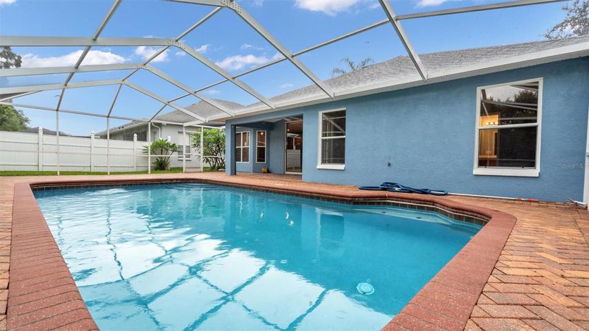 In-ground pool with pavers, screened in with plenty of privacy