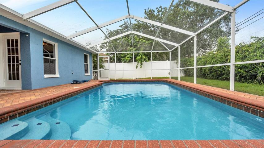 In-ground pool with pavers, screened in with plenty of privacy