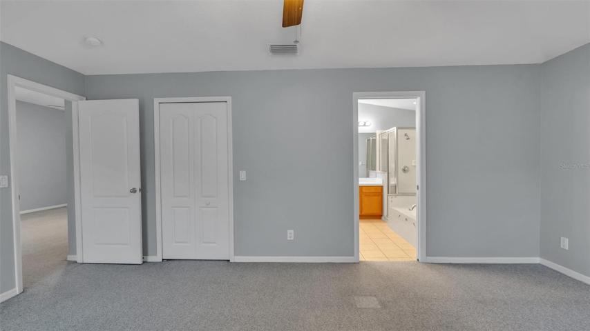 Primary bedroom with en-suite bathroom and large walk-in closet