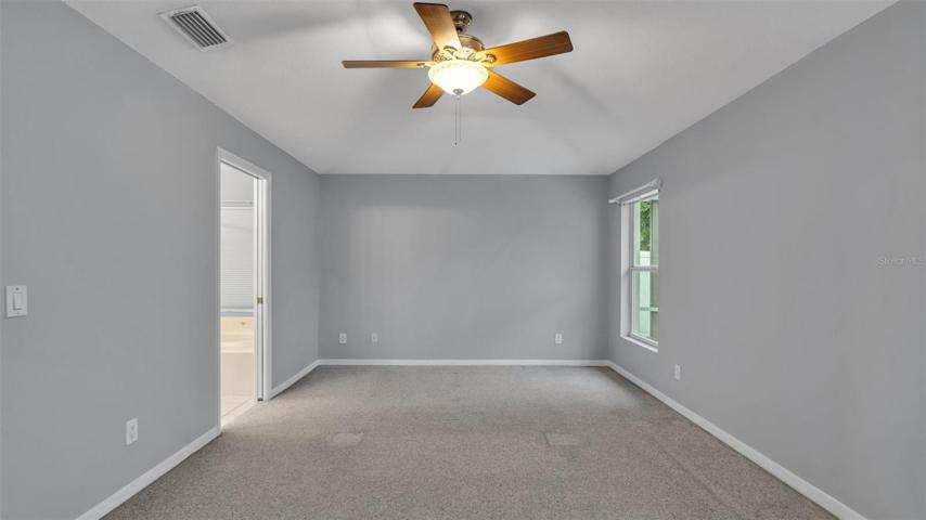 Primary bedroom with a view to the pool
