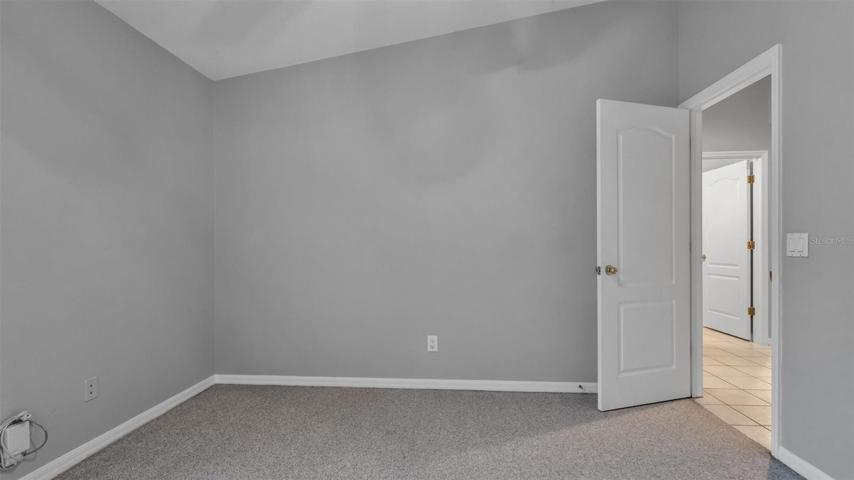 Third bedroom - vaulted ceiling and carpet