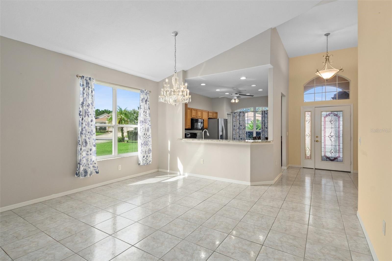 Same view, just taken from closer to the entertainment niche. The dining area window brightens the home, along with the leaded glass entry door and sidelight.