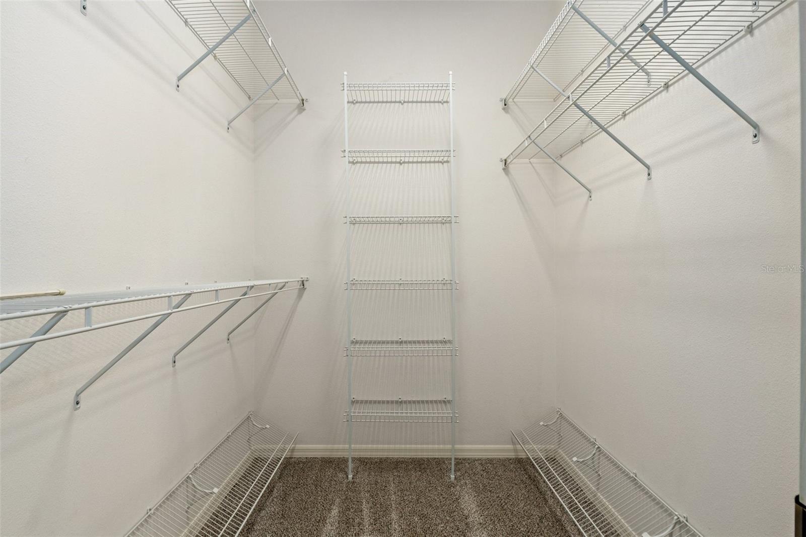 The master bedroom walk-in closet, accessible from the bedroom via a pocket door.