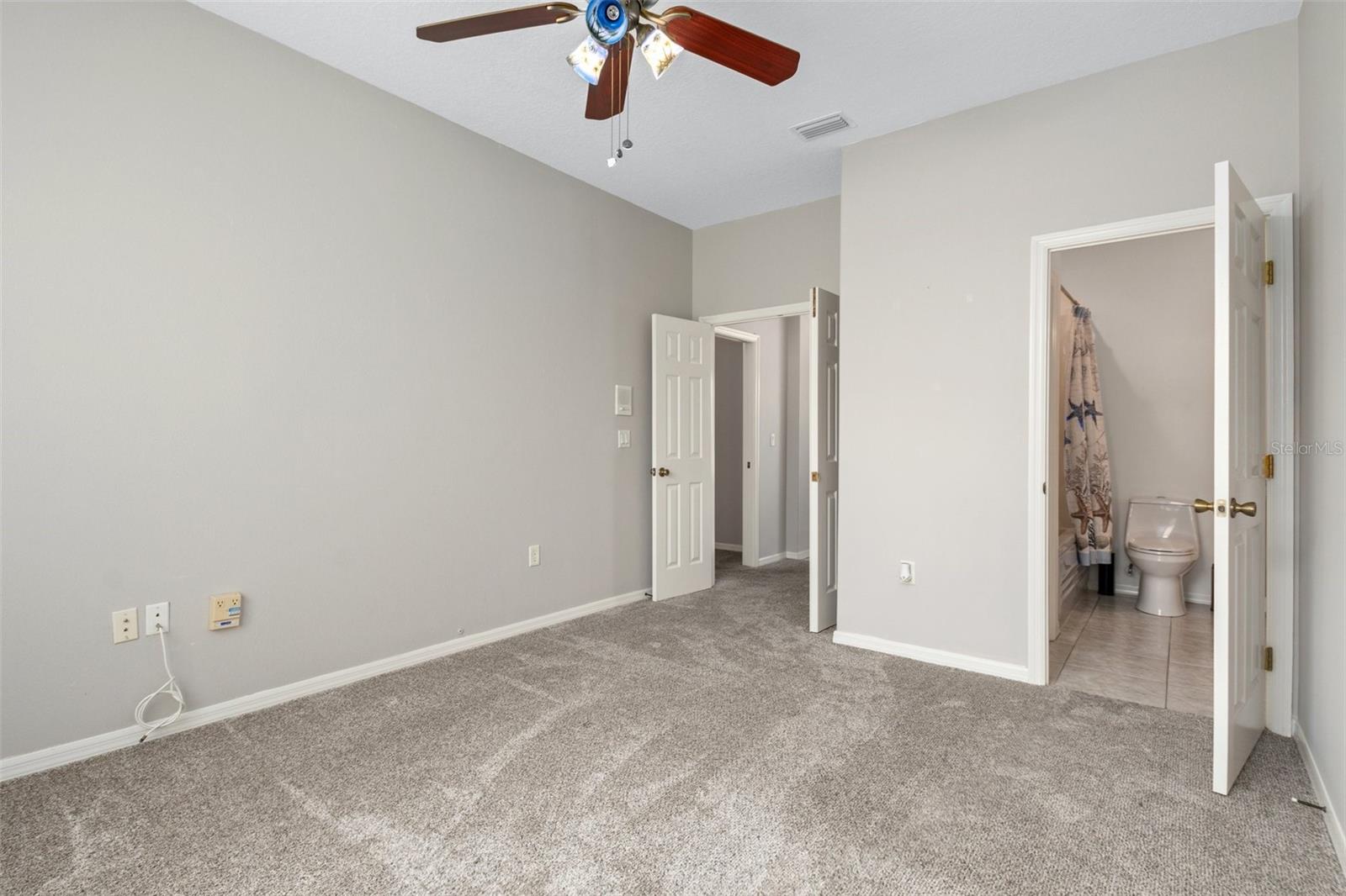 Opposite view looking from window across to French Door entry. The doorway on the right is to the Jack and Jill bath that is shared with the front guest bedroom.