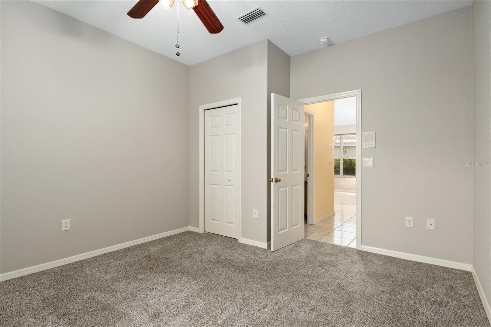 View from corner of bedroom looking back toward bedroom door. The opening just outside bedroom to the left is to the Jack and Jill Guest Bath. Opposite the bedroom door is the dining area.