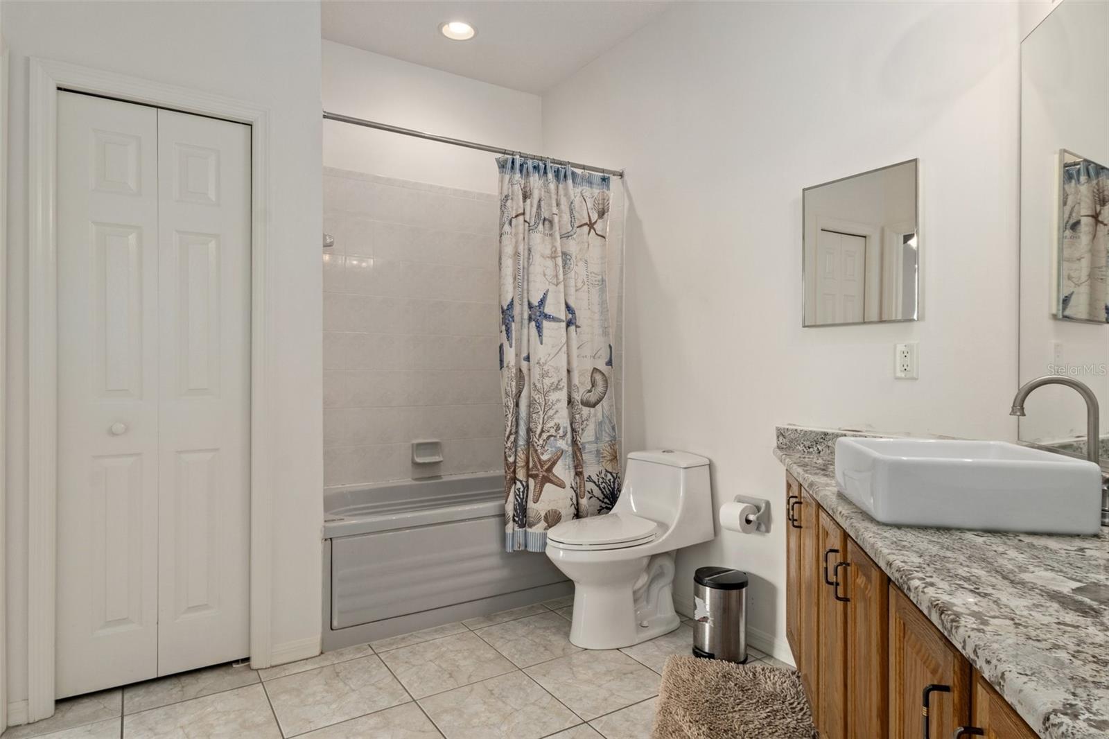 The Jack and Jill guest bath has its own linen closet and a jetted tub.