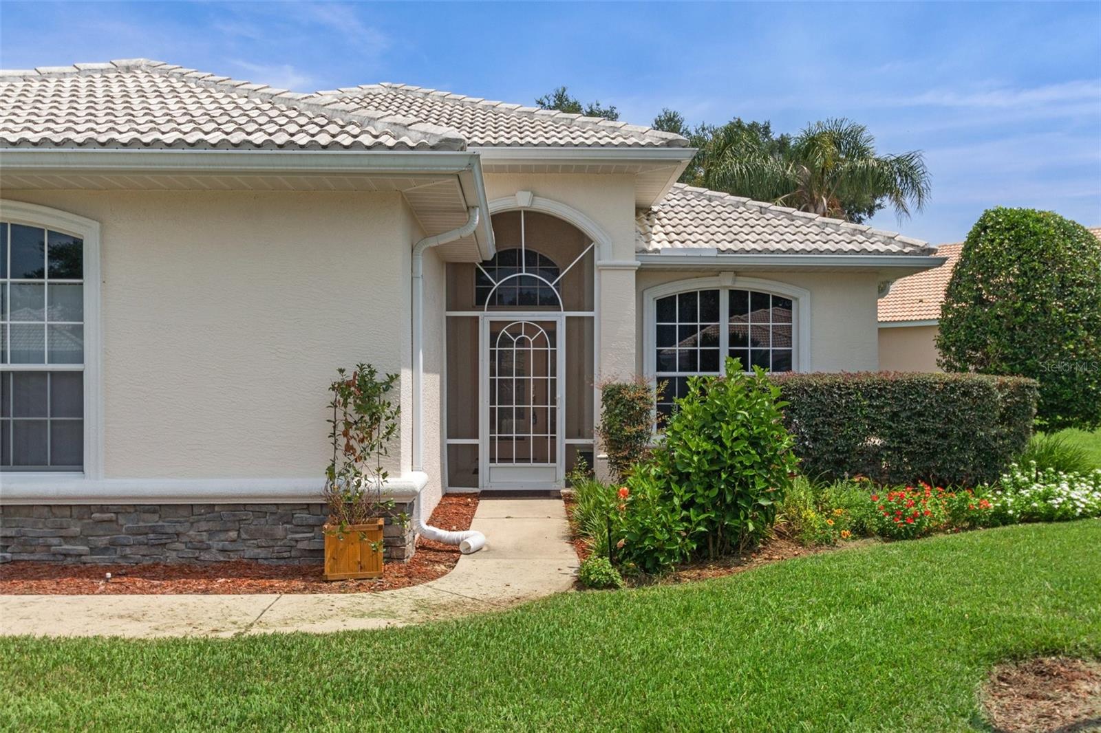 Welcoming covered and screened entryway.