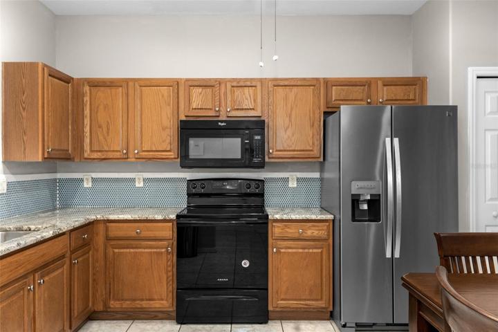 View to the right in the kitchen. To the left is the breakfast bar, sink, and the view into the great room seen in the last picture.
