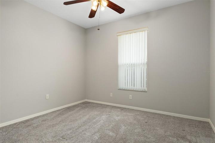 The front guest bedroom features a ceiling fan and newer carpet as well.
